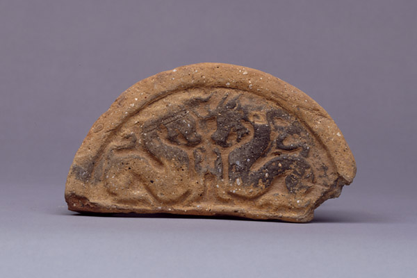 Semi-Circular Eave-End Roof Tile with Confronted Dragons. Kyoto National Museum